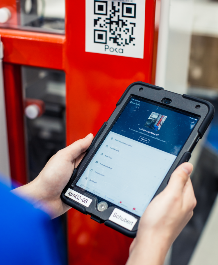 factory worker holding an ipad with digital work instructions